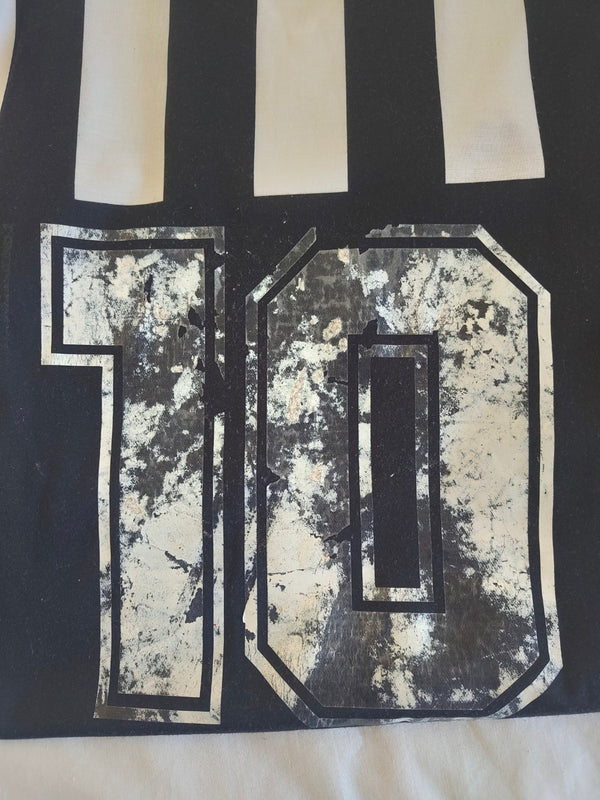 Home football shirt close-up of number 10 print, worn effect on black and white stripes