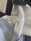 Home football shirt inner neck label: 100% polyester, size/fit details, black and white