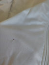 White track jacket fabric close-up with visible weave texture
