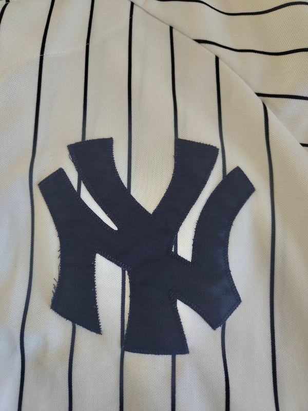 White Yankees pinstripe baseball jersey with navy NY logo patch